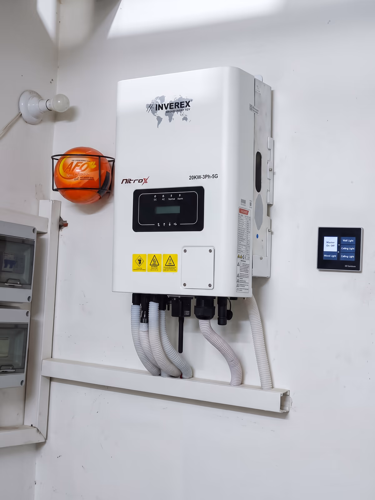 Inverex Nitrox 20 kW three-phase inverter on the wall with its string cables in white conduit